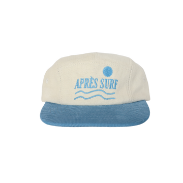 A beige and blue corduroy five-panel hat with 'APRÉS SURF' embroidered on the front panel.