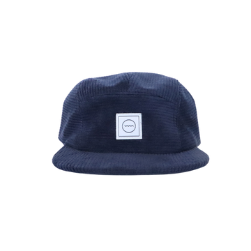 A slate gray corduroy five-panel hat with an adjustable velcro back and fabric eyelets on the side panels. It features a square brand logo on the front.