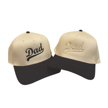Two beige and black caps with 'Dad' text on a white background