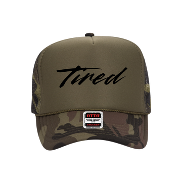 Camouflage and brown trucker hat with 'Tired' text and Otto label on a white background