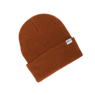 A brown waffle knit beanie with a fold-over cuff, displayed on a neutral background.