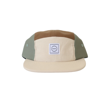 A beige and green cotton five-panel hat with an adjustable velcro back and fabric eyelets on the side panels, designed for kids.
