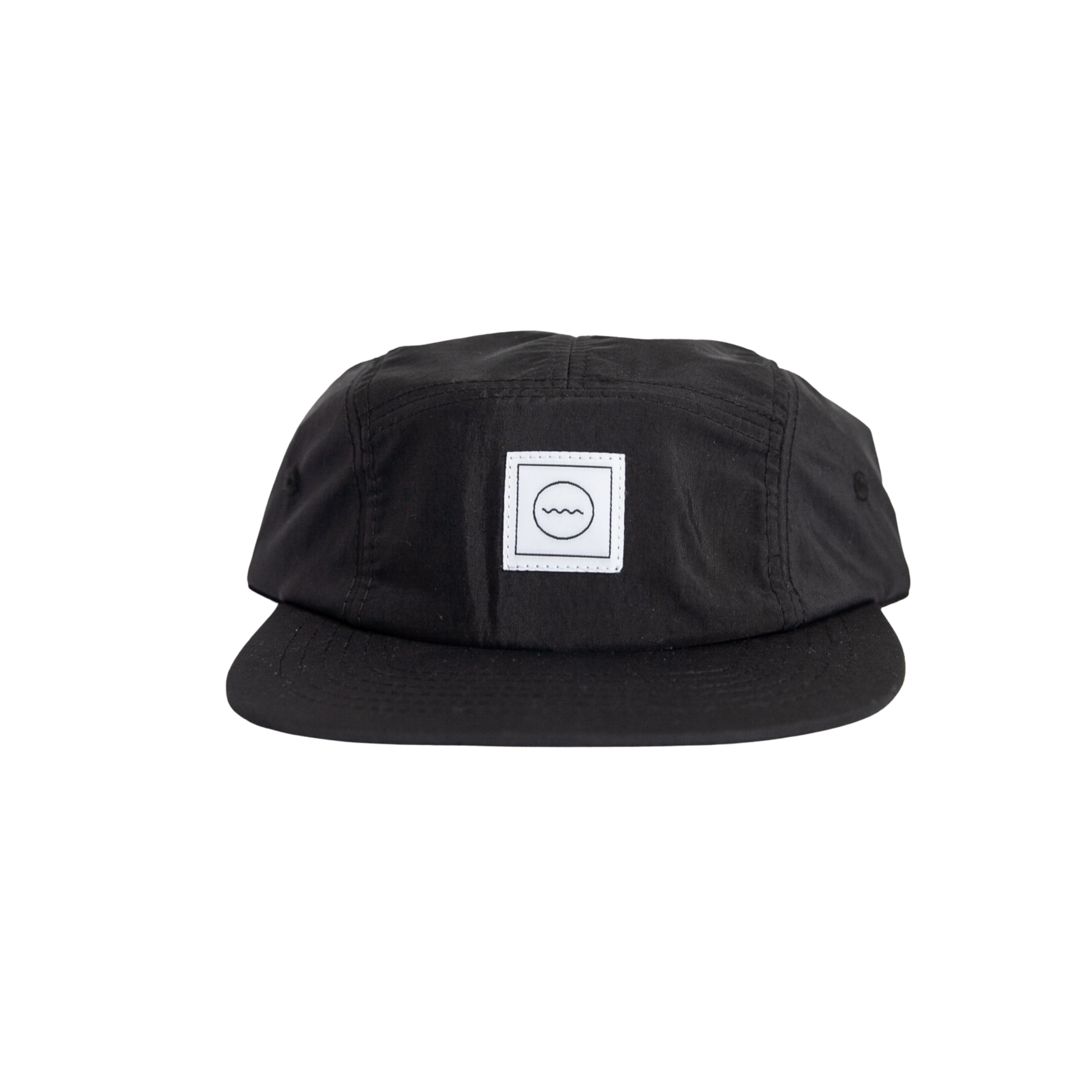 A black nylon five-panel hat with an adjustable velcro back and fabric eyelets on the side panels. It features a white square logo on the front.