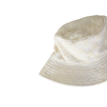A beige bucket hat with a checkered pattern.
