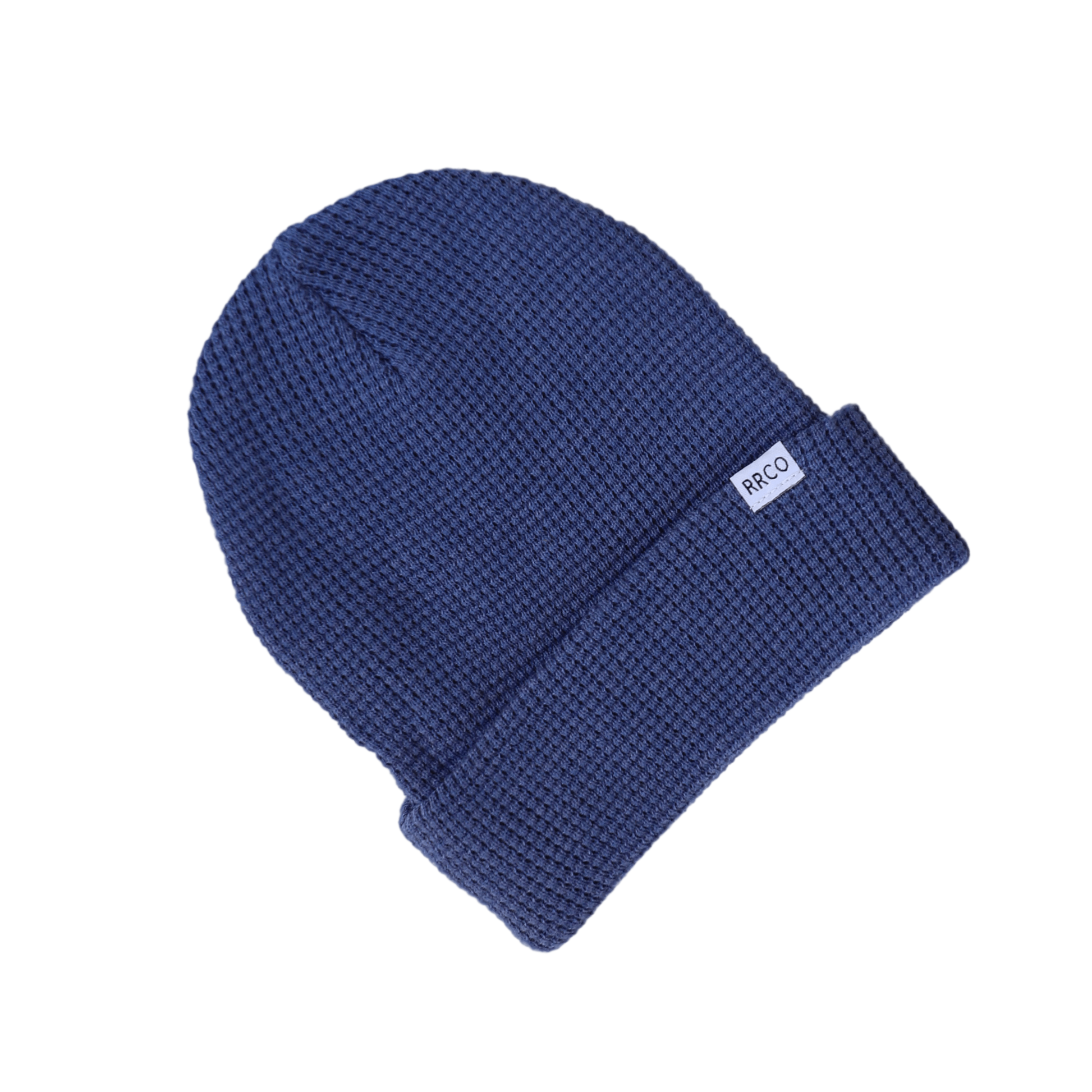A blue waffle knit beanie with a fold-over cuff, displayed on a neutral background.