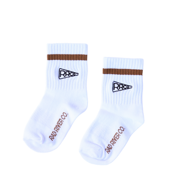 A pair of white socks with a brown band and logo, against a white background.